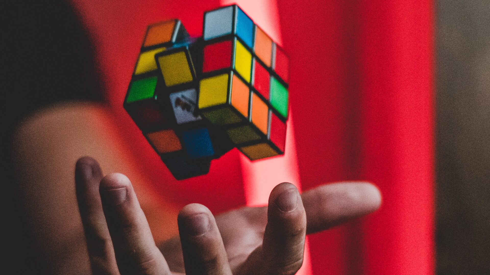 Photo of a hand catching a Rubick's cube