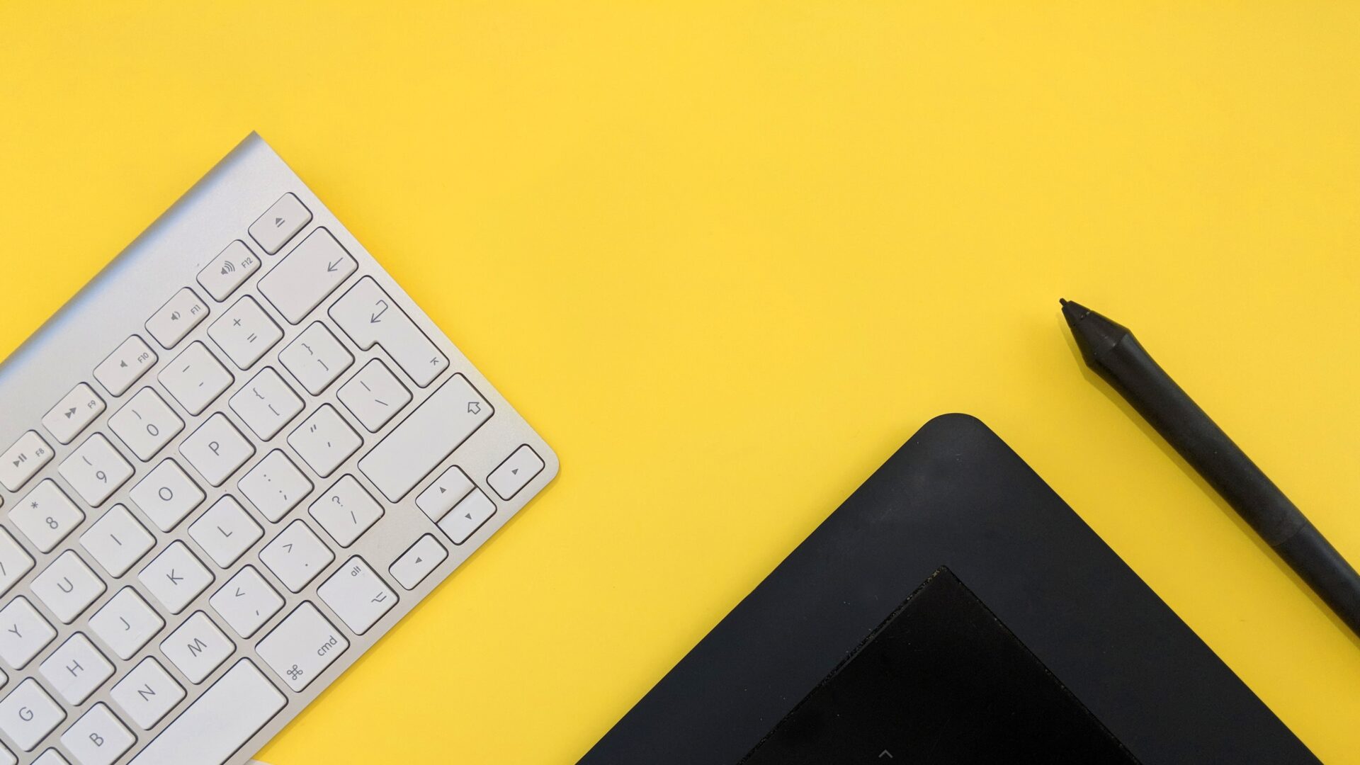 Picture of keyboard and tablet with a yellow background